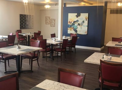 Interior view of a dining area with tables and chairs