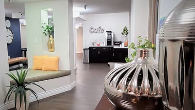 Bright common area with seating and cafe in the background