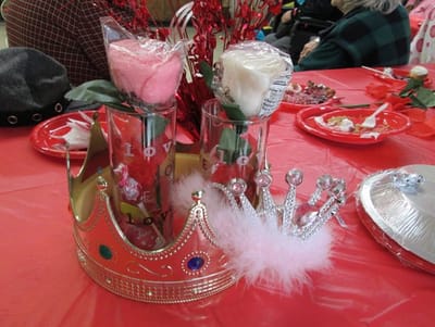 Decorative table setting for a celebration with crowns and flowers