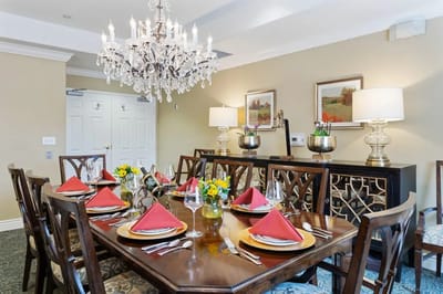 Elegant dining room setup with chandelier and floral centerpieces