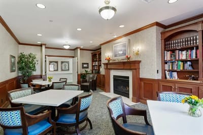 Bright interior common area with seating and fireplace