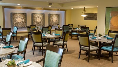 Elegant dining room setup with tables and artwork