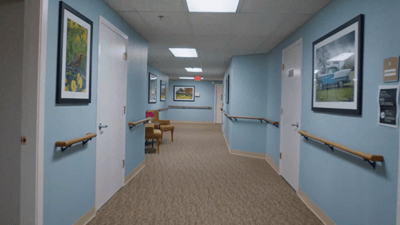 Bright corridor with framed artwork and no occupants