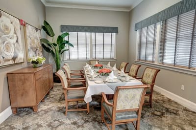Elegant dining room setup with a long table and floral centerpiece