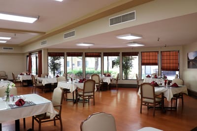 Bright dining room with tables set for meals