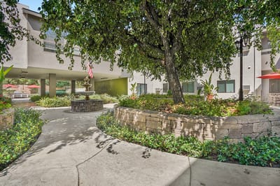 Outdoor courtyard area with greenery and fountain