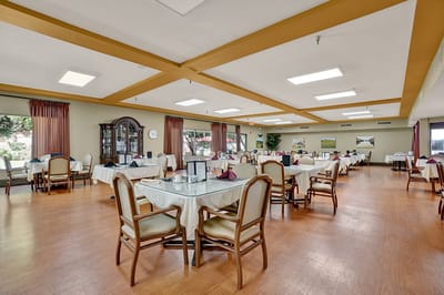 Bright dining area with tables and chairs set for meals