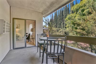 Balcony view with outdoor seating and greenery