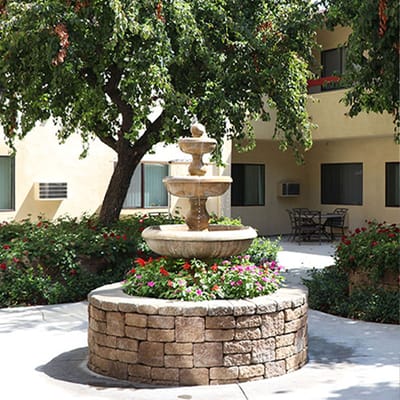 Beautiful outdoor fountain surrounded by flowers