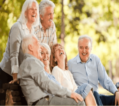 Sungarden Terrace, assisted living in Lemon Grove, CA — Seniors laughing together in a natural outdoor setting