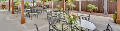 Outdoor seating area with tables and flowers