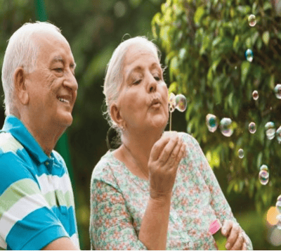 Sungarden Terrace, assisted living in Lemon Grove, CA — Senior couple enjoying bubble blowing outdoors