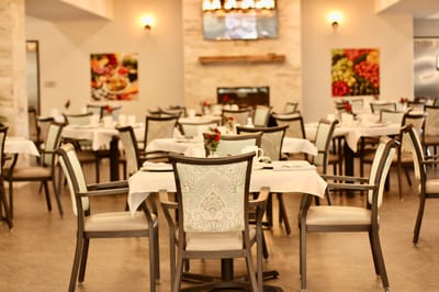 Dining room setup with tables and chairs in an interior space