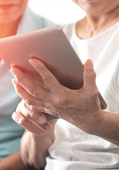 Close-up of a person's hand holding a tablet