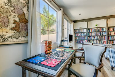 Puzzle table in a cozy common area with bookshelves