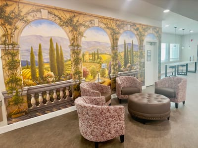 Interior seating area with mural and chairs