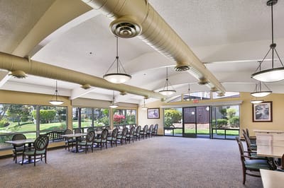 Bright dining area with large windows and seating