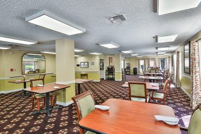 Dining area with tables and chairs in a warm interior