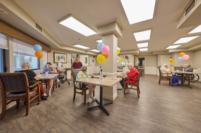 Residents participating in a colorful activity in a common area