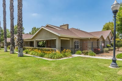 Exterior view of the Cottages at Hemet with gardens