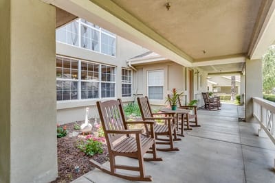 Outdoor seating area with rocking chairs and flowers