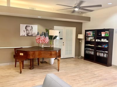 Interior view of a social area with a piano and decorations