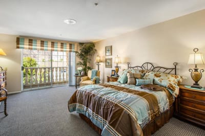 Brightly lit private resident room with balcony