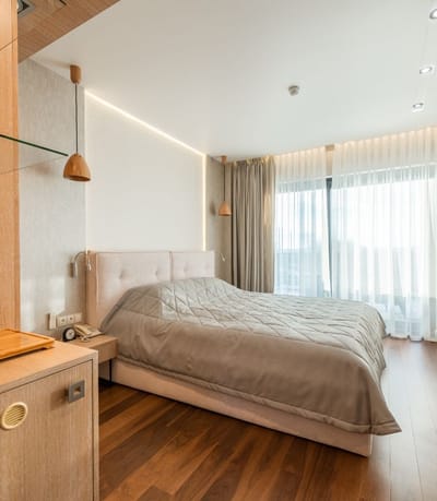 Well-furnished resident room with large windows and modern decor