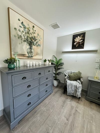 Cozy interior with a dresser and decorative plants