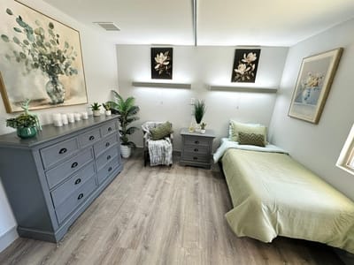Cozy interior of a resident room with a bed and decor