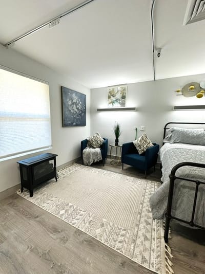 A well-decorated private resident room with seating area