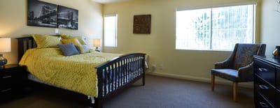 Cozy private bedroom featuring a bed and artwork