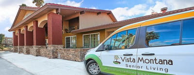 Facility building entrance with branded vehicle