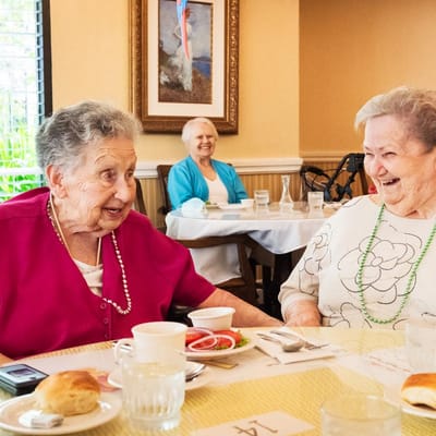 Two women chatting over a meal in a dining area