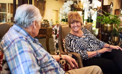 Two residents engaged in conversation in a common area