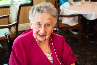 Resident smiling in an indoor setting
