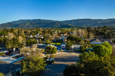Aerial view of a charming community surrounded by mountains