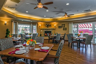 Dining area with tables set for meals and flowers