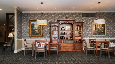 Cozy common area with floral wallpaper and furniture
