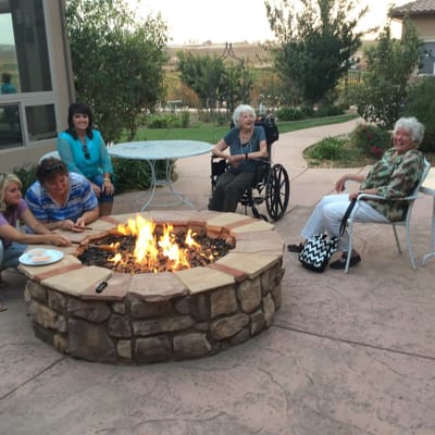 Residents gathered around a fire pit in an outdoor space