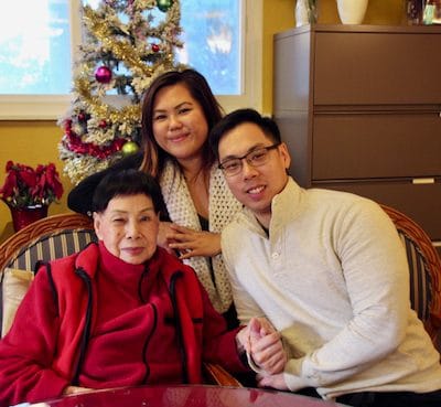 A resident with family members in a cozy interior setting