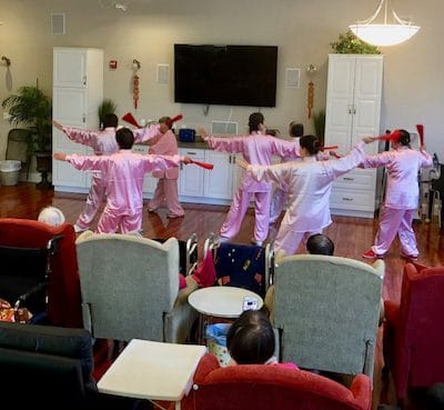Residents participating in an exercise class in a common area