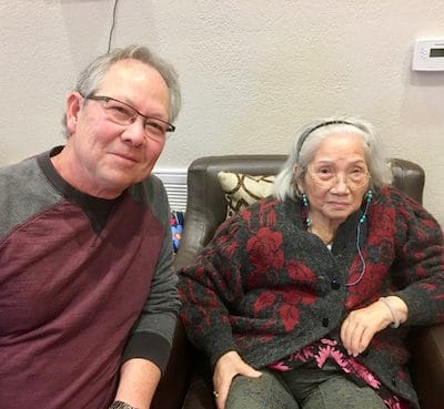 A man and a woman sitting together in a cozy indoor setting