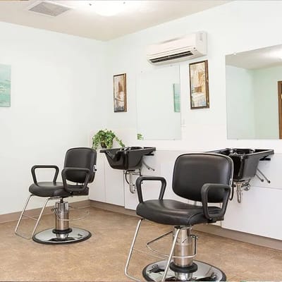 Salon area with chairs and sinks for residents