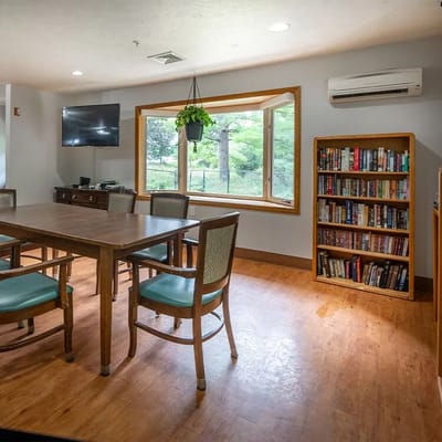Bright common area with a table and bookshelf
