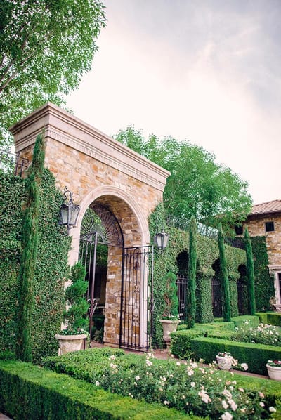 Well-maintained outdoor garden area with stone archway