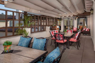 Outdoor patio area with colorful furniture and plants