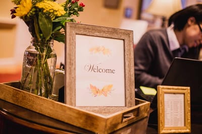 Welcome sign and flowers in a cozy lobby setting