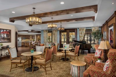 Common area with seating and piano in a senior living facility