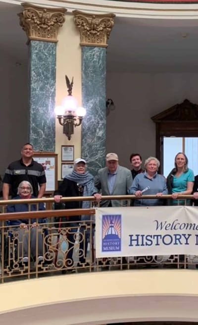 Residents and staff posing in a welcoming interior space